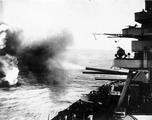 Battleship USS New York firing its 14 in main guns on Iwo Jima