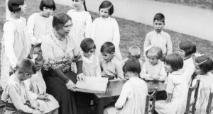 Helen Keller reading to blind children