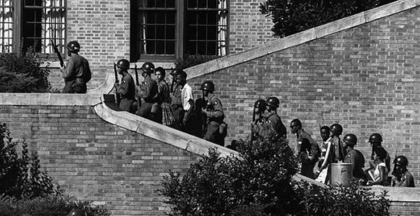 Little Rock Nine being escorted by US army