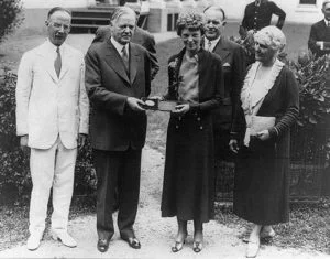 Herbert Hoover presenting the National Geographic Society gold medal to Amelia Earhart