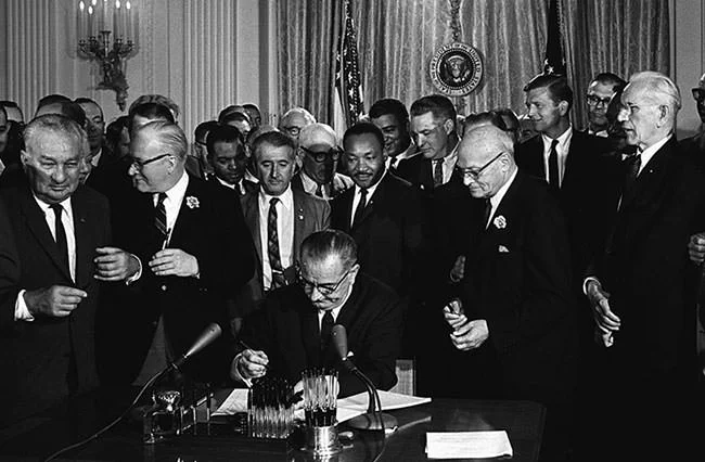 Lyndon B. Johnson signs the Civil Rights Act of 1964