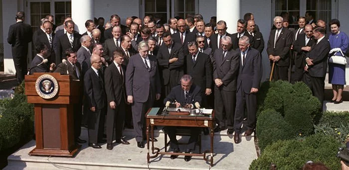 President Johnson signs the Economic Opportunity Act of 1964
