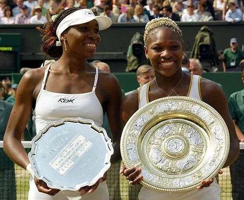 Serena and Venus Williams with Wimbledon trophies
